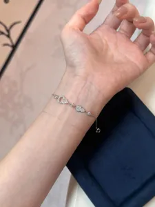 Detalle de pulsera de plata S925 con circón, dijes brillantes de corazón y calabaza.