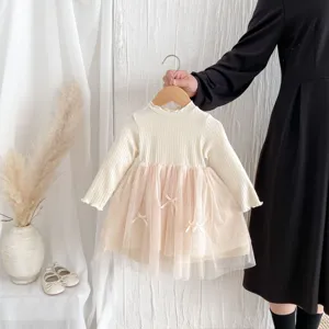 Toddler girl dress detail showing rib knit top, pink tutu tulle skirt, and cute bows.