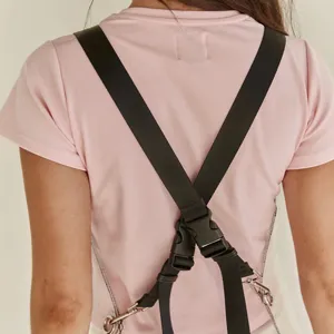 Detail view of transparent TPU waterproof apron with black cross straps and metal hardware.