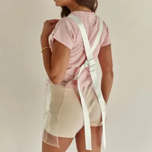 Detail view of transparent TPU waterproof apron back cross straps and metal rings.