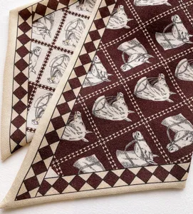 Luxurious silk wool twilly scarf with equestrian horse head print and geometric diamond border.