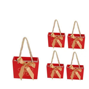 Red paper gift bags with gold ribbon handles, perfect for wedding party favors, candies, and events.