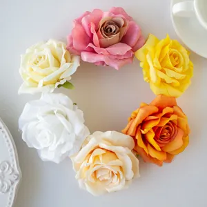Artificial rose flower head detail close up multi color DIY craft material background