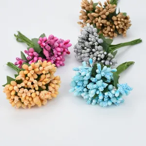 Detailed view of colorful artificial berry bunches, perfect for DIY crafts and decorations.