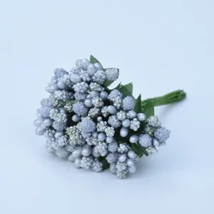 Close-up detail of silver artificial berries and pearl beads for DIY crafts and decor.