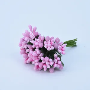 Close-up detail of pink artificial berries and pearl beads bouquet for DIY craft decoration.