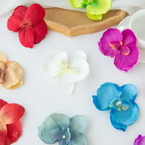 Artificial orchid flower heads detail view, colorful fabric flowers for DIY crafts and home decor.