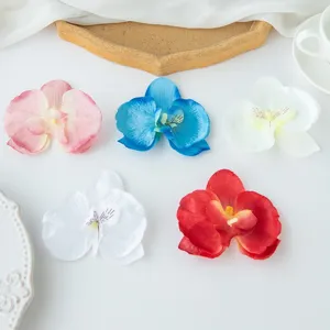 Artificial phalaenopsis orchid flowers detail shot, colorful DIY craft decor display.