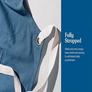 Cotton linen apron detail shot featuring durable reinforced white straps and brass ring.