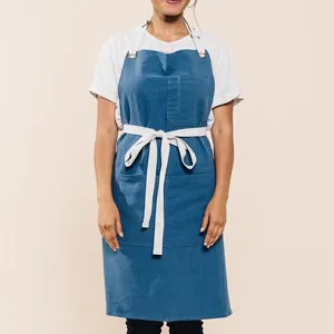 Cotton linen blend kitchen apron with cross back straps and pockets for daily cooking wear.