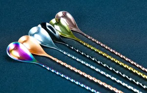 Detailed view of long bar spoons with twisted stems, colorful metallic finish for cocktail mixing.