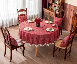 Nappe ronde jacquard rouge du Nouvel An avec pompons et coussins pour décoration de salle à manger.