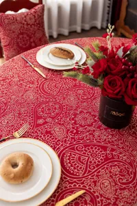 Nappe jacquard rouge festive avec motif floral doré, parfaite pour table ronde et déco de mariage.