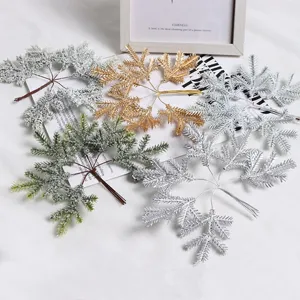Artificial Christmas pine branches details, frosted snow decorative picks for tree and garland.