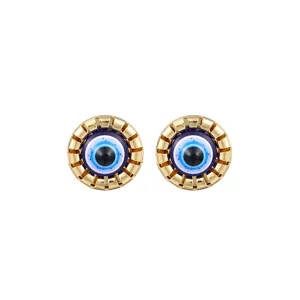 Detailed close-up of stylish gold evil eye stud earrings, trendy accessory for daily wear.