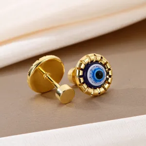Gold evil eye stud earrings detail shot, chic drop oil design, premium fashion jewelry.