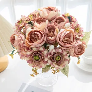 Detailed close-up of artificial peony flower bouquet in glass vase for home living room decor.