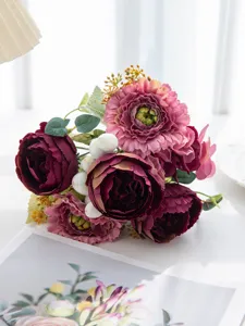 Detailed view of artificial flower bouquet featuring faux peonies and berries.