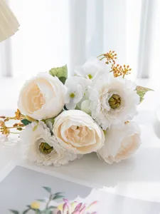 Close-up detail of white artificial peony bouquet, elegant floral decor for home and dining table.