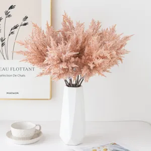Detailed view of artificial pampas grass bouquet in white ceramic vase for home decor.