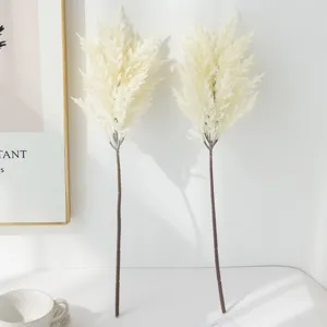 Artificial pampas grass stems, fluffy white dried flowers for home decor detail view.