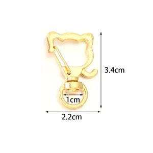 Detailed close-up of the cute cat shaped gold metal swivel lobster clasp for DIY crafts.