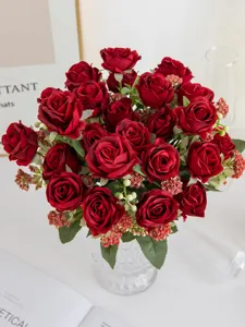 Artificial red rose flower bouquet with berries for home wedding decor and table centerpiece.