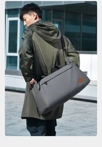 Detail view of large capacity travel duffel bag in grey, showing durable strap and fabric.