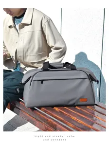 Outdoor detail shot of a spacious grey travel duffel bag on a wooden bench for trips.