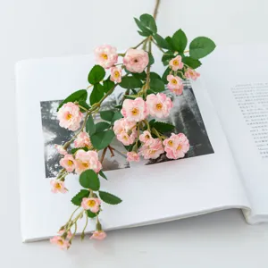 Artificial pink mini rose flower branch, detailed view for home decor and photography props.