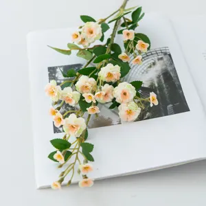 Detailed close-up of artificial small rose flower branch, perfect for home decor and photography.
