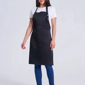 Black halter work apron detail, featuring front pockets and metal snaps for daily kitchen use.