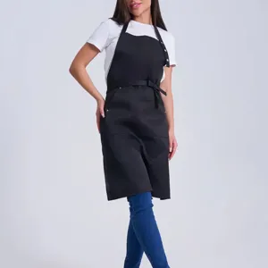 Black work apron detail view, adjustable halter neck and convenient pockets for daily use.