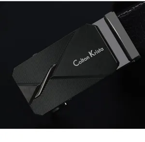 Close-up of a black metal automatic belt buckle with geometric brushed design and text.