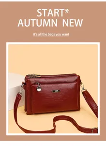 Detailed view of retro PU leather multi-layer shoulder bag, wine red with metal hardware.