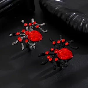 Detailed macro view of Gothic punk spider rings decorated with vibrant red rhinestones