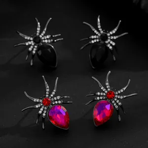 Detailed close-up of punk style rhinestone spider jewelry with red and black crystals