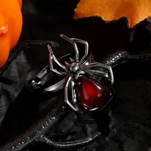 Close-up of gothic spider ring with red gemstone for Halloween theme