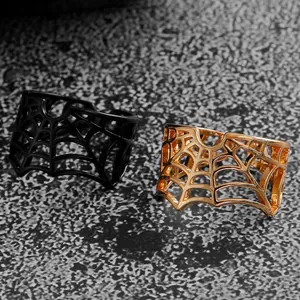 Detailed macro shot of gothic punk spiderweb rings in black and gold finishes