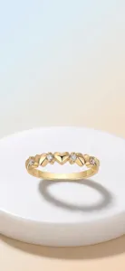 Detailed macro view of an elegant heart-shaped golden ring with sparkling moissanite stones