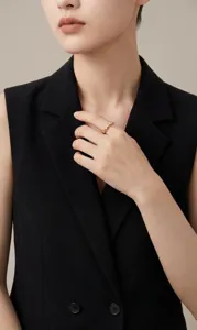 Close-up detail of a golden S925 silver heart ring with moissanite on a model's finger