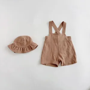 Baby solid color romper and hat set details, cute summer infant clothing, soft fabric.