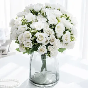 Artificial white rose flower bouquet with glass vase for home wedding party decoration.