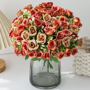 Artificial rose flower bouquet with grey glass vase for home wedding decor detail shot.