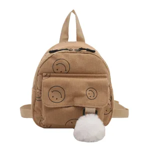 Mini corduroy backpack for women, cute casual school bag with smiley face print and pom pom.