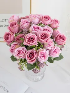 Detailed closeup of artificial pink rose bouquet in clear glass vase, perfect for home decor display.