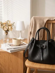 Stylish black leather bucket bag with chic belt buckle, perfect for casual and daily commuting use.