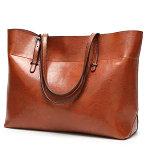Detailed view of brown PU leather tote bag texture, dual straps and metallic hardware.