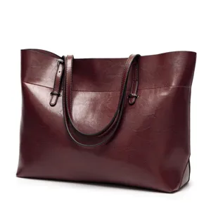 Dark burgundy PU leather tote bag detail, featuring dual shoulder straps and metal rings.