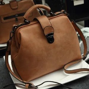 Detailed view of brown retro PU leather doctor bag with sturdy handle and shoulder strap.